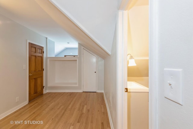 14557 W Ave, Orland Park, IL 60462 - hallway featuring light wood-style floors, lofted ceiling, and baseboards
