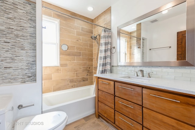 full bathroom with vanity, toilet, shower / bath combo with shower curtain, and backsplash