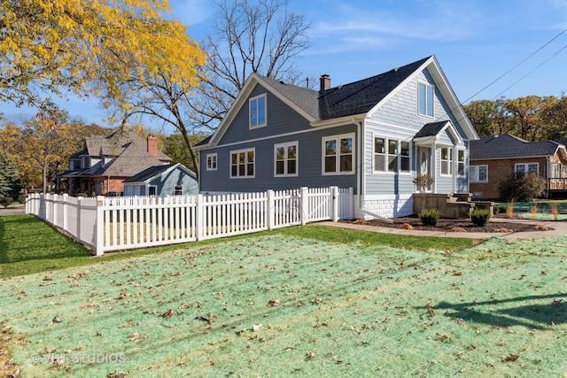 back of house with a yard