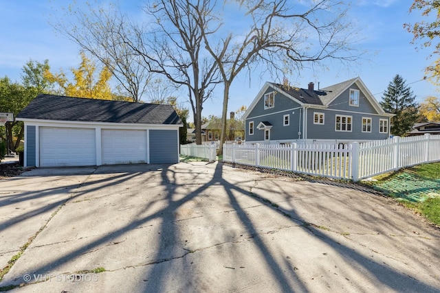 14557 W Ave, Orland Park, IL 60462 - view of home's exterior with an outdoor structure, a garage, and a chimney