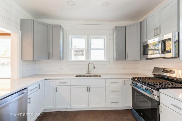 14557 W Ave, Orland Park, IL 60462 - kitchen featuring stainless steel appliances, a sink, light stone countertops, gray cabinetry, and dark wood-style floors