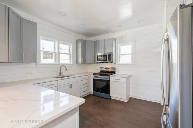 14557 W Ave, Orland Park, IL 60462 - kitchen featuring stainless steel appliances, a sink, light stone counters, plenty of natural light, and ornamental molding
