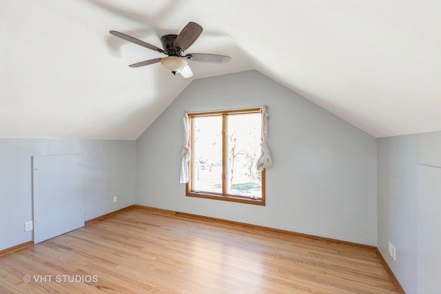 additional living space with ceiling fan, light wood-type flooring, and vaulted ceiling