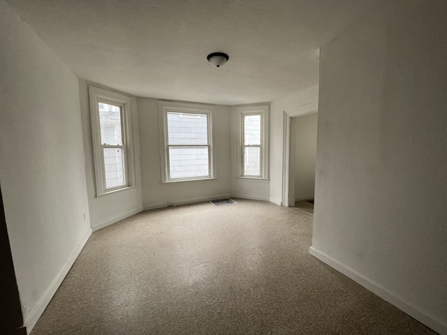 unfurnished room with light carpet