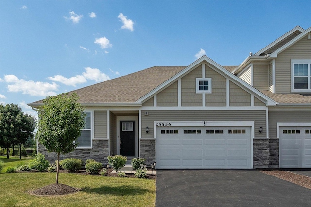 25556 W Springview Dr, Plainfield, IL 60586 - craftsman house with stone siding, asphalt driveway, a front yard, and a shingled roof