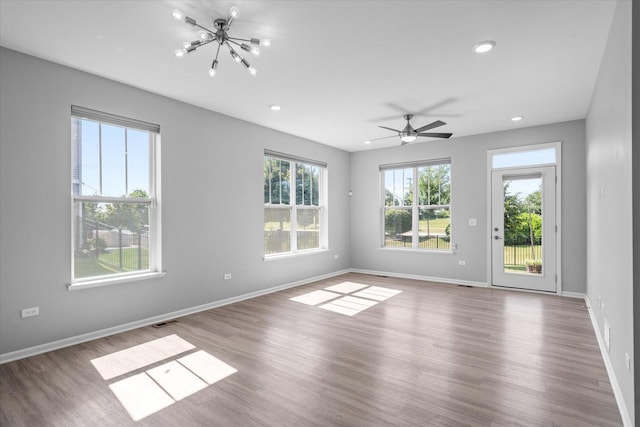 25556 W Springview Dr, Plainfield, IL 60586 - empty room with plenty of natural light, wood finished floors, a chandelier, recessed lighting, and ceiling fan