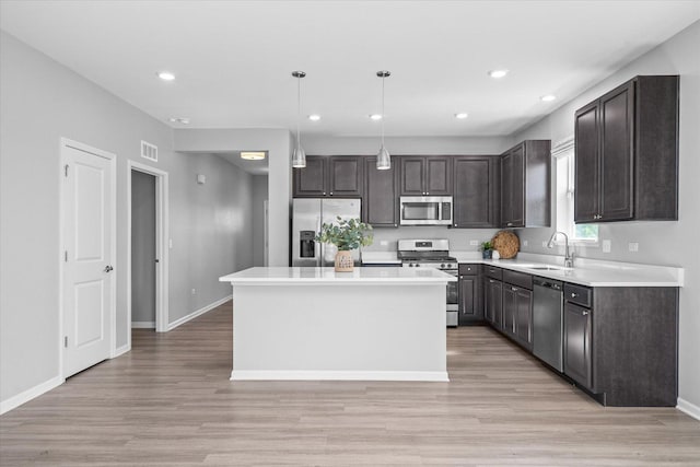 25556 W Springview Dr, Plainfield, IL 60586 - kitchen featuring appliances with stainless steel finishes, light wood-style flooring, dark brown cabinetry, recessed lighting, and light countertops