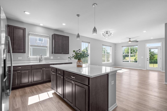 25556 W Springview Dr, Plainfield, IL 60586 - kitchen with stainless steel fridge, light wood-style floors, light countertops, dark brown cabinets, and recessed lighting