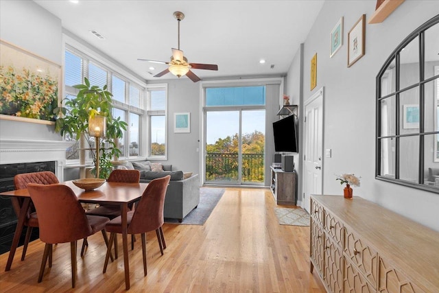 dining space with ceiling fan and light hardwood / wood-style floors