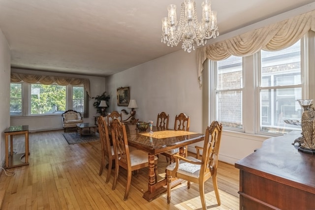 dining room featuring light hardwood / wood-style flooring and a chandelier