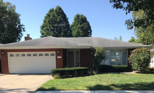 single story home with a garage and a front lawn