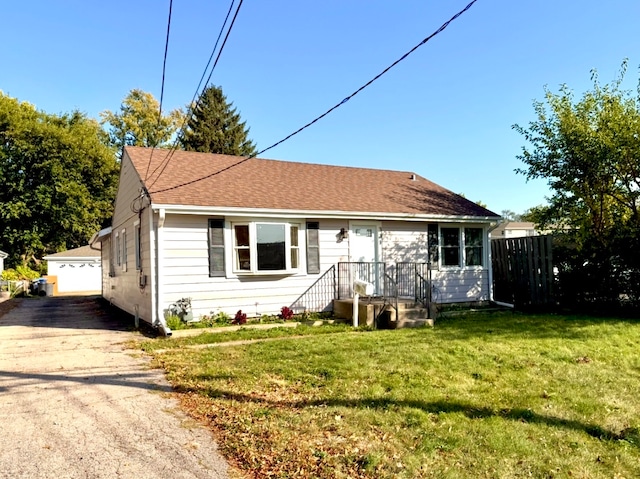 single story home featuring a garage and a front lawn