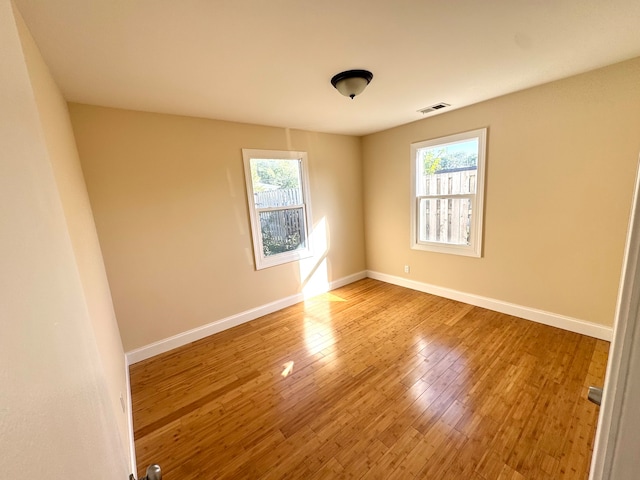 unfurnished room featuring hardwood / wood-style floors