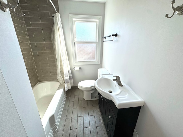 full bathroom with wood-type flooring, vanity, shower / bath combo with shower curtain, and toilet