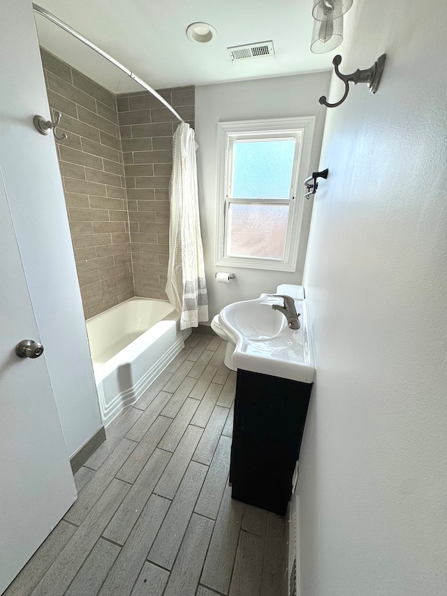 full bathroom featuring shower / tub combo, vanity, and toilet