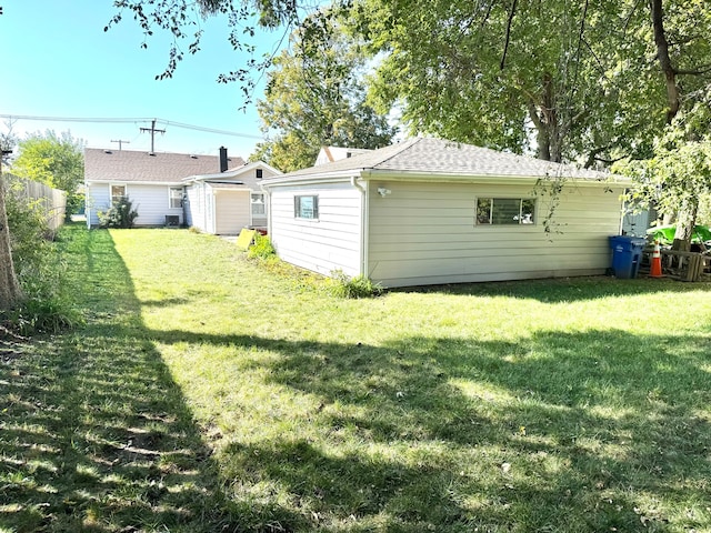 rear view of property with a lawn