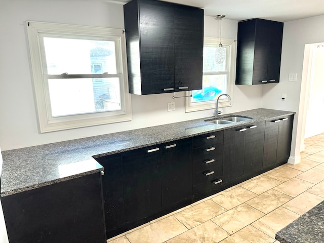 kitchen with decorative light fixtures, a healthy amount of sunlight, and sink