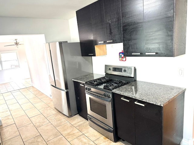 kitchen featuring light stone counters, stainless steel appliances, and ceiling fan