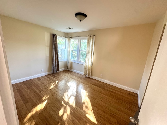 spare room with wood-type flooring