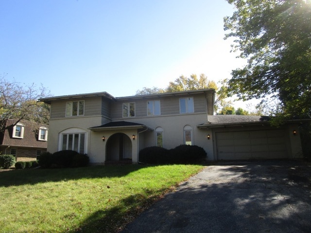 view of front of house with a garage and a front lawn