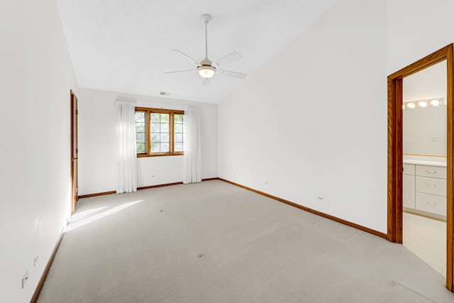 carpeted spare room with vaulted ceiling and ceiling fan