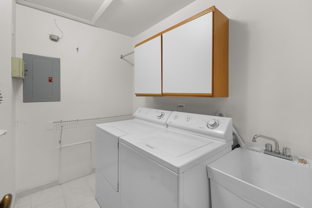 washroom featuring electric panel, light tile patterned floors, sink, cabinets, and washer and dryer