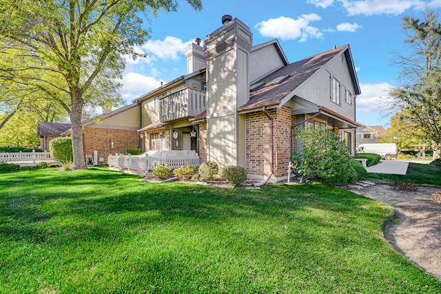 view of side of property with a lawn