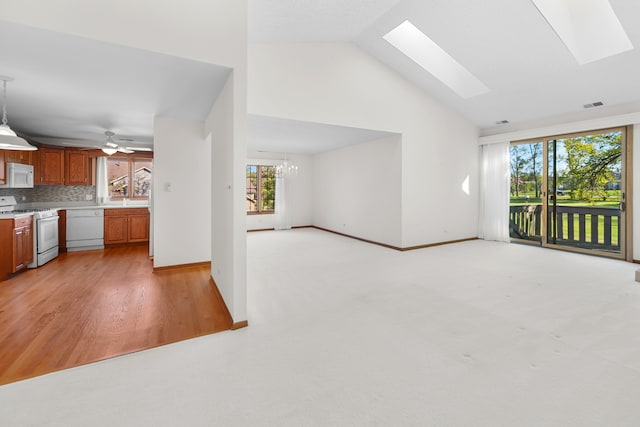 kitchen featuring high vaulted ceiling, backsplash, white appliances, pendant lighting, and light wood-type flooring