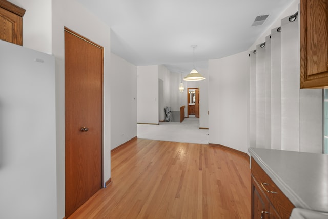 unfurnished dining area featuring light wood-type flooring