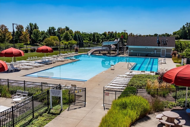 view of pool featuring a patio and a water slide