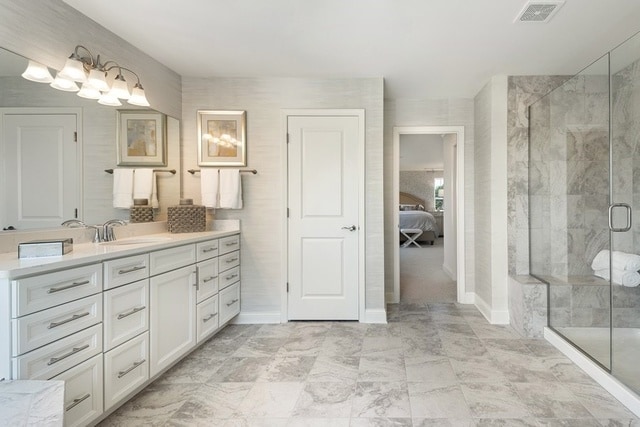 bathroom with an enclosed shower and vanity