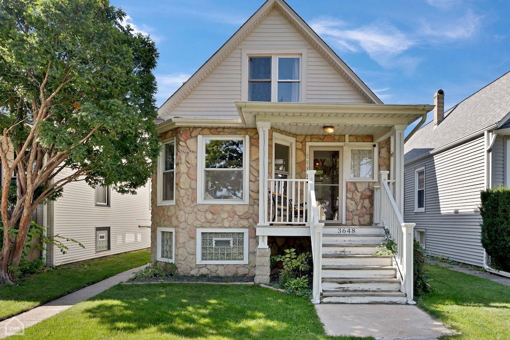 bungalow-style house featuring a porch and a front yard