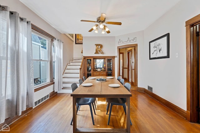 dining room with ceiling fan and light hardwood / wood-style floors