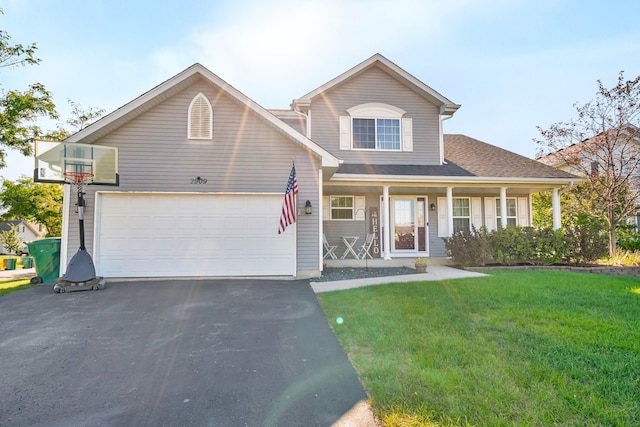 view of front of house featuring a porch, a front yard, and a garage