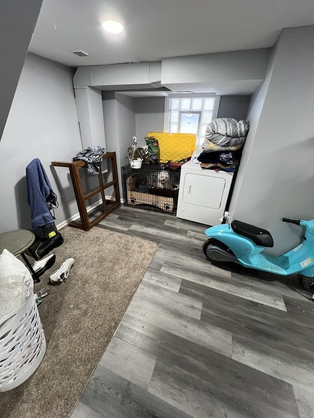 exercise area with washer / clothes dryer and hardwood / wood-style flooring