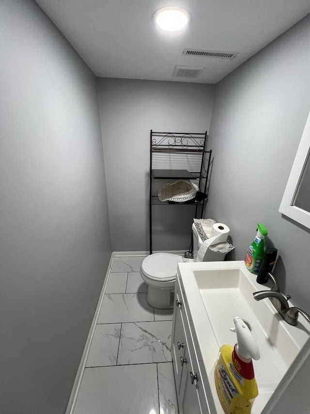 bathroom featuring vanity and toilet