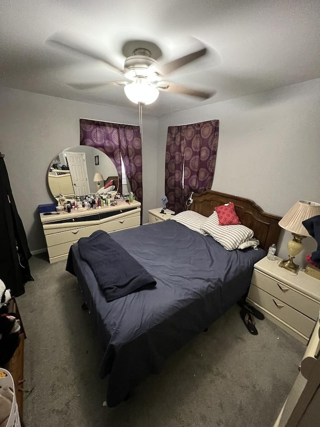 bedroom with ceiling fan and dark colored carpet