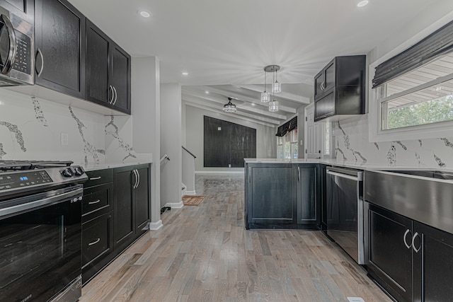 kitchen featuring beam ceiling, tasteful backsplash, decorative light fixtures, light hardwood / wood-style flooring, and stainless steel appliances