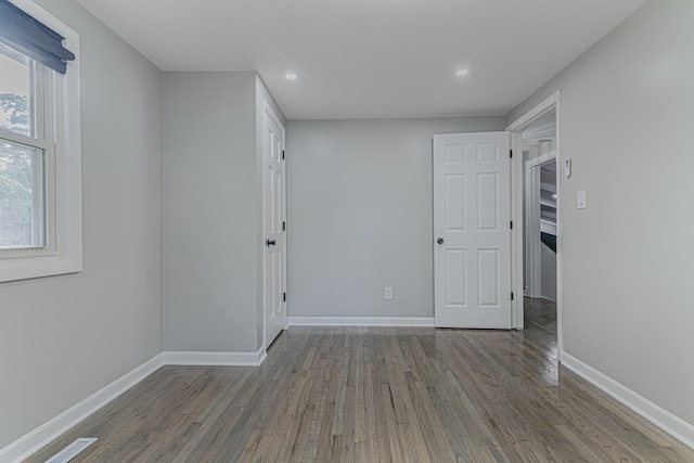 unfurnished room with hardwood / wood-style flooring