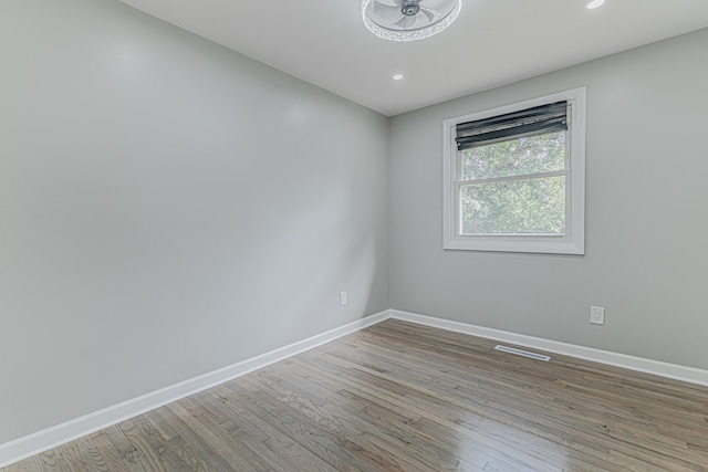 spare room with light hardwood / wood-style flooring