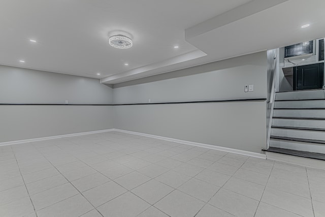 basement featuring light tile patterned floors