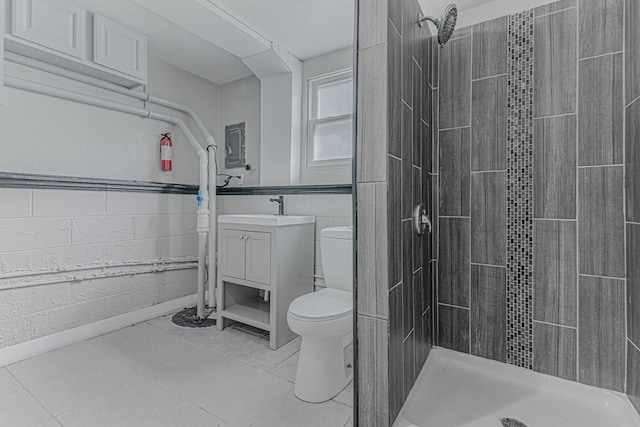 bathroom featuring vanity, toilet, and tiled shower