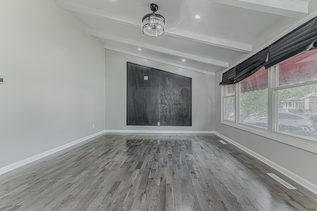 spare room with lofted ceiling with beams and hardwood / wood-style flooring