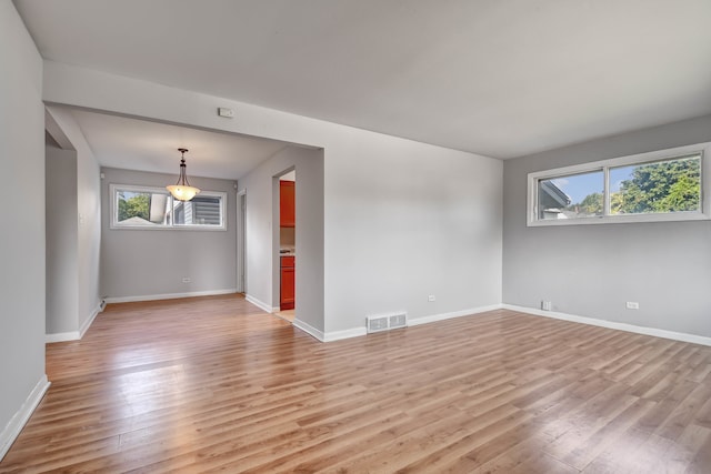 spare room featuring light wood-type flooring