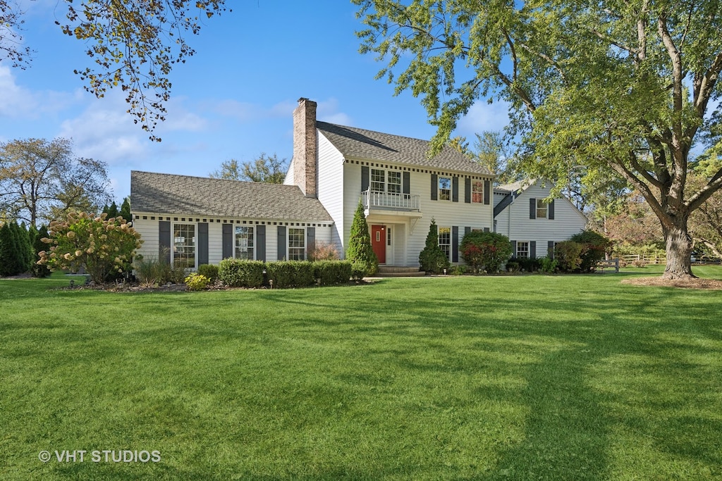 colonial home with a front lawn