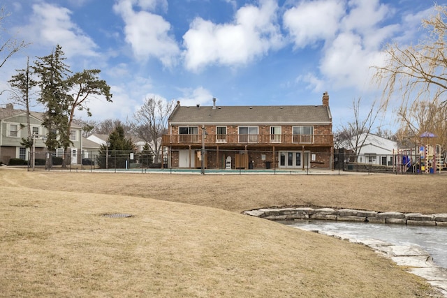 back of property featuring a community pool, a yard, and french doors