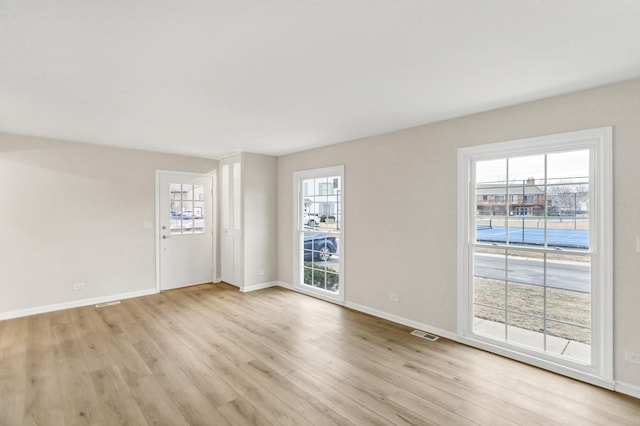 spare room featuring light hardwood / wood-style floors