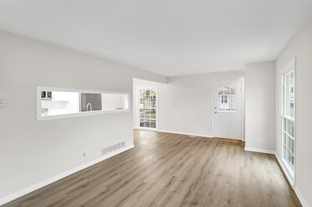 unfurnished living room with light wood-type flooring