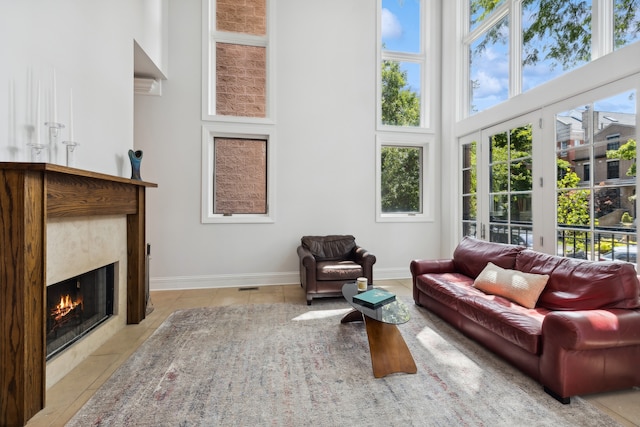 sunroom featuring a high end fireplace