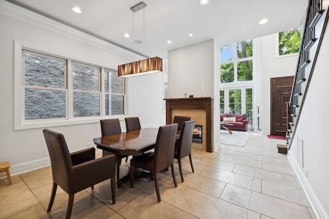 dining space with crown molding and light tile patterned floors